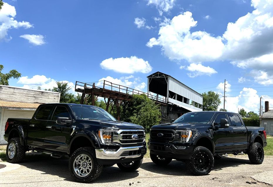 Two lifted black Ford F-150s parked at a grain elevator in Chillicothe, Ohio