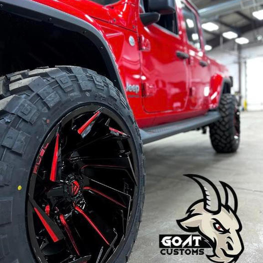 Close up of a red Jeep Gladiator's red and black off-road wheel