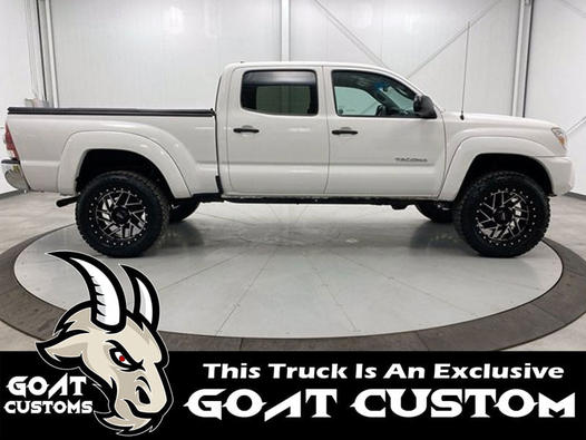 White Toyota Tacoma custom build on a rotating showroom turntable